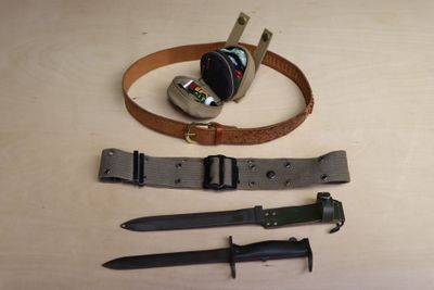 a knife, belt, and other items on a table