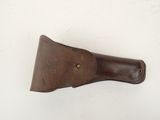 brown leather sheath for a knife on a white surface