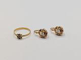 three gold rings, one with a skull and one with a skull head