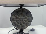 a lamp that is sitting on a table with a lamp shade on it
