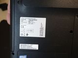 a person holding a laptop that has a sticker on it