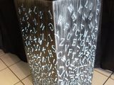 a metal trash can with letters written on it