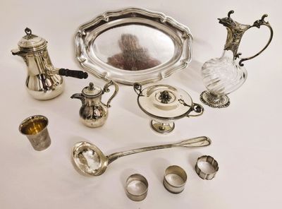 a silver plate and silverware on a white table