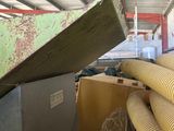a large pile of pipes in a room with a roof