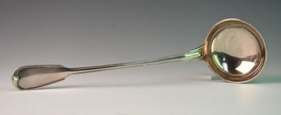 a silver spoon with a spoon handle on a table