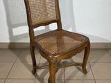 a wooden chair that is sitting on a tile floor