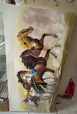 un tableau représentant un homme à cheval, posé sur un chevalet