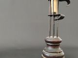 a candle that is sitting on top of a metal pole