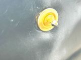 a close up of a car door handle with a yellow button