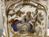 a vase with a picture of a woman sitting on a bench
