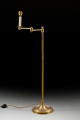 a brass plated floor lamp with a white glass shade