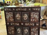 a wooden chest of drawers that is in a room