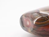 a close up of a glass vase on a white surface