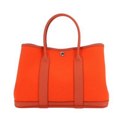 a large orange handbag on a white background