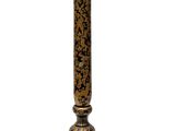 an image of a tall candle holder with a clock on top of it