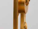 a gold clock on a marble base on a table