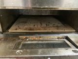 a pizza oven with a pizza inside of it