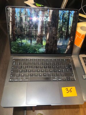a laptop computer sitting on a table with a price tag