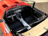 a red sports car with a steering and dashboard