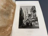 un livre ouvert avec, au milieu, l'illustration d'une scène de rue