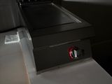 a black stove top sitting on a counter in a kitchen