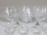 six wine glasses sitting on a table with a white background