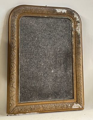 an old gold framed mirror on a white wall with a black background