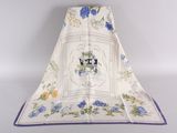 a white towel with blue flowers and a picture of a cat on it