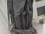 a black bag sitting on top of a luggage cart