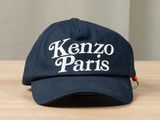 the kenzo paris hat is sitting on a wooden table