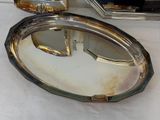 a silver tray with a mirror on it on a table