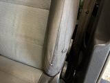 a close up of a seat in a car with the arm rest down