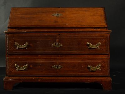 an old wooden chest of drawers with brass handles on a black background