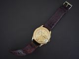 an image of a wrist watch on a black surface