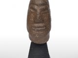 sculpture of a face on a black base