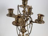 brass candelab with a black marble vase on a marble base