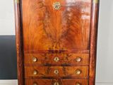 an antique wooden chest of drawers with brass hardware