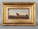 tableau représentant un paysage, dans un cadre doré, accroché à un mur gris