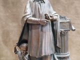a statue of a man with a dog and a mailbox
