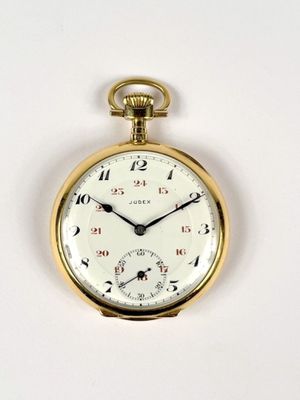 a close up of a pocket watch on a white surface