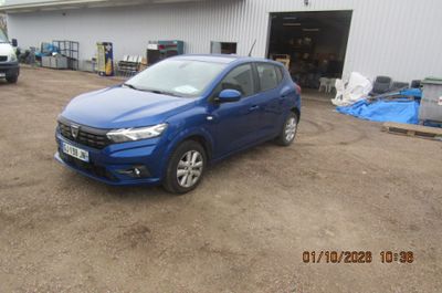 une photo d'une voiture bleue garée devant un immeuble