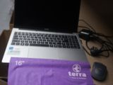 a laptop computer sitting on top of a purple bag next to a mouse