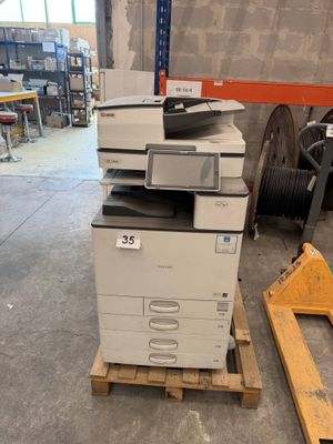a printer that is sitting on a pallet in a warehouse
