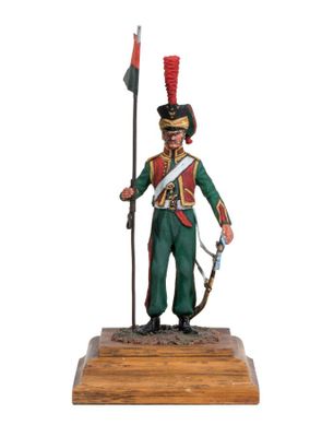 the toy soldier is holding a rifle and a flag
