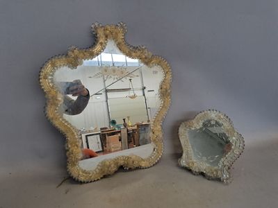 two mirrors that are sitting next to each other