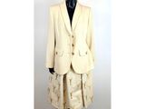 the mannequin is wearing a suit and skirt with gold stars on it