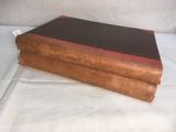 an old book sitting on top of a white sheet on a table