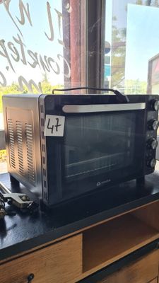 a microwave sitting on top of a counter next to a window