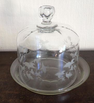 a glass plate with a glass dome on it
