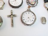 many different types of watches displayed on a table